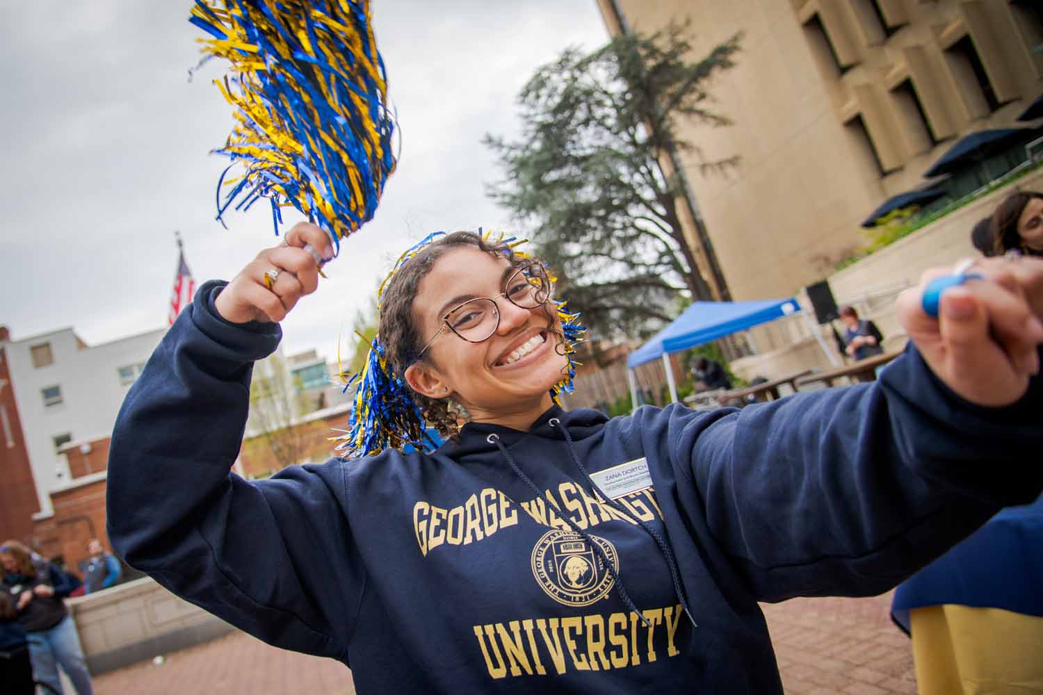 A person poses with a pompom in Kogan plaza on Giving Day 2025